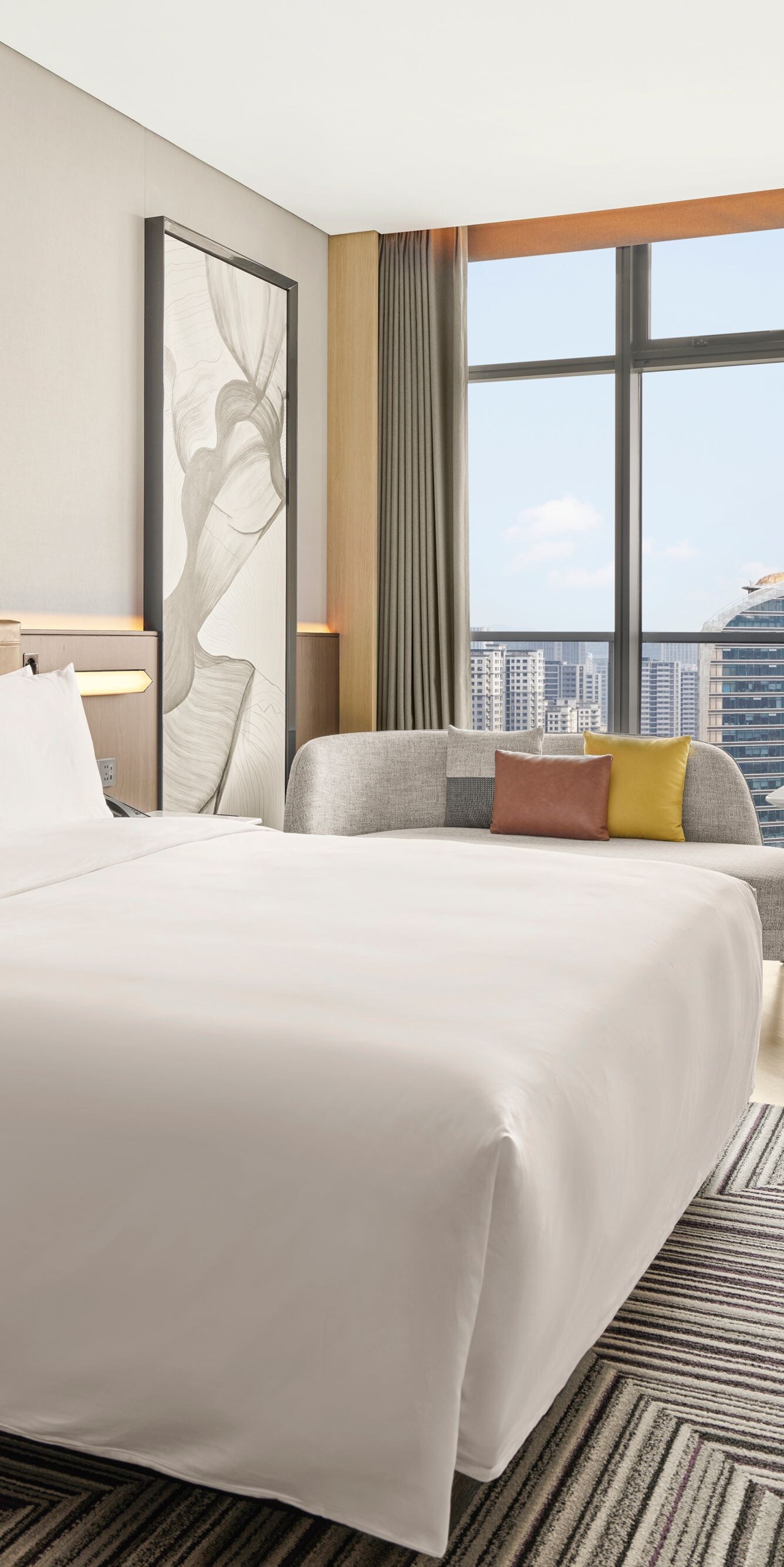 Bright guest room with city skyline views
