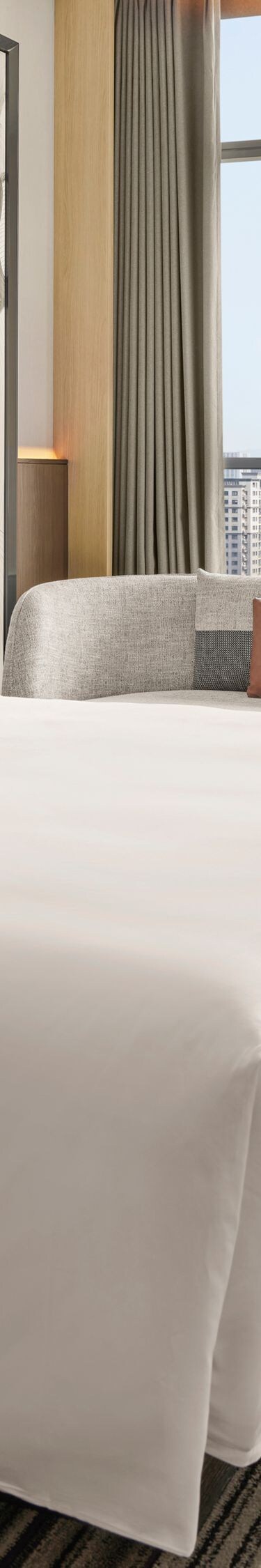 Bright guest room with city skyline views
