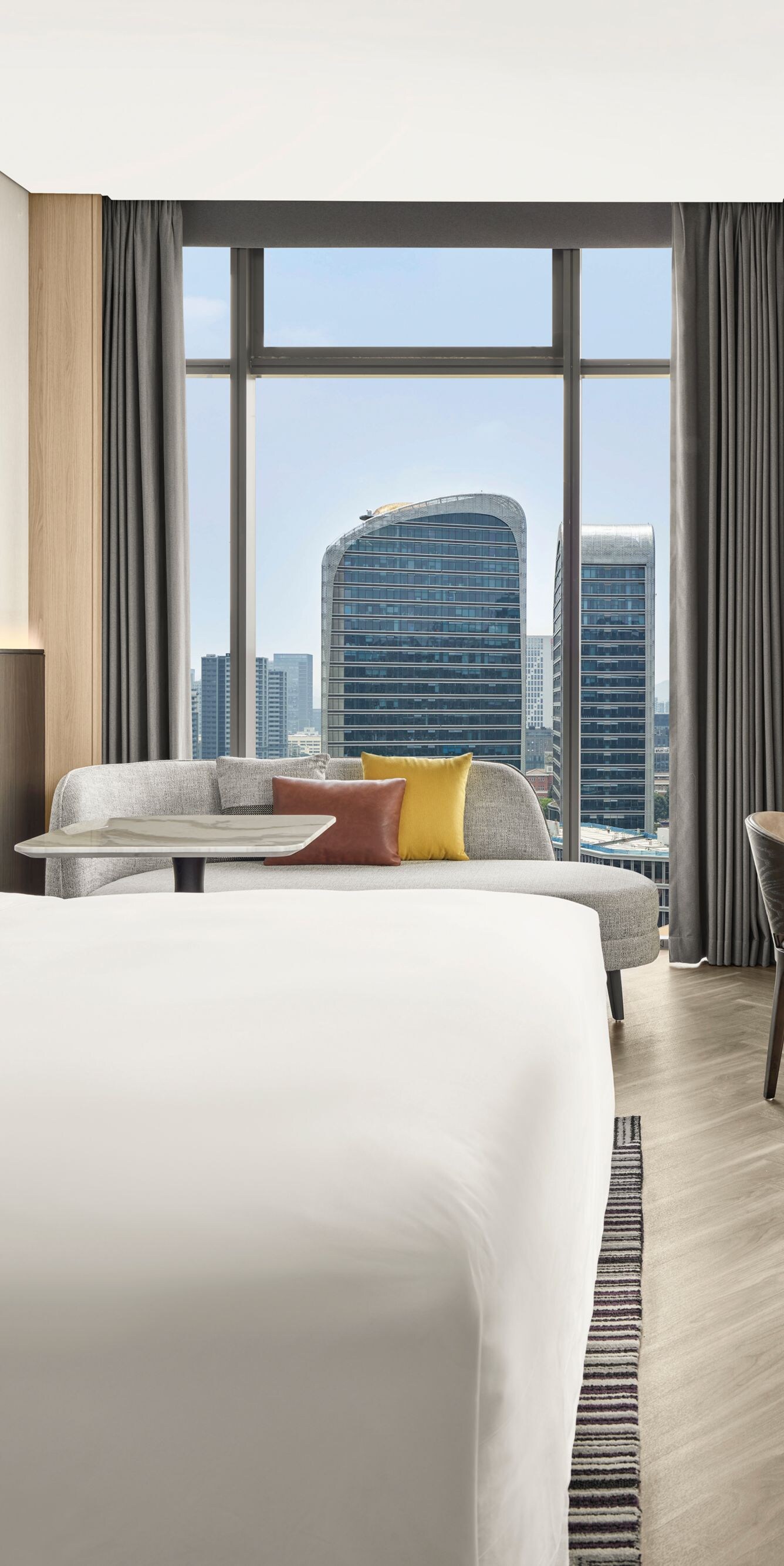 Modern guest room with king bed and skyline view