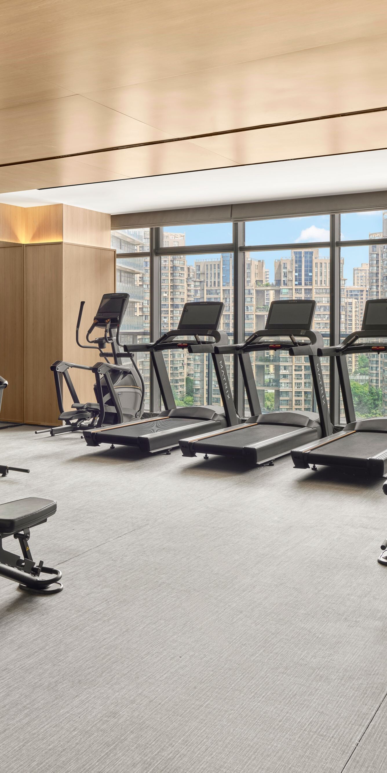fitness center with cardio equipment and weights