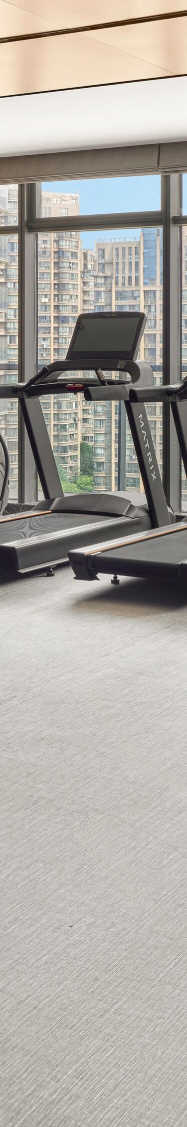 fitness center with cardio equipment and weights