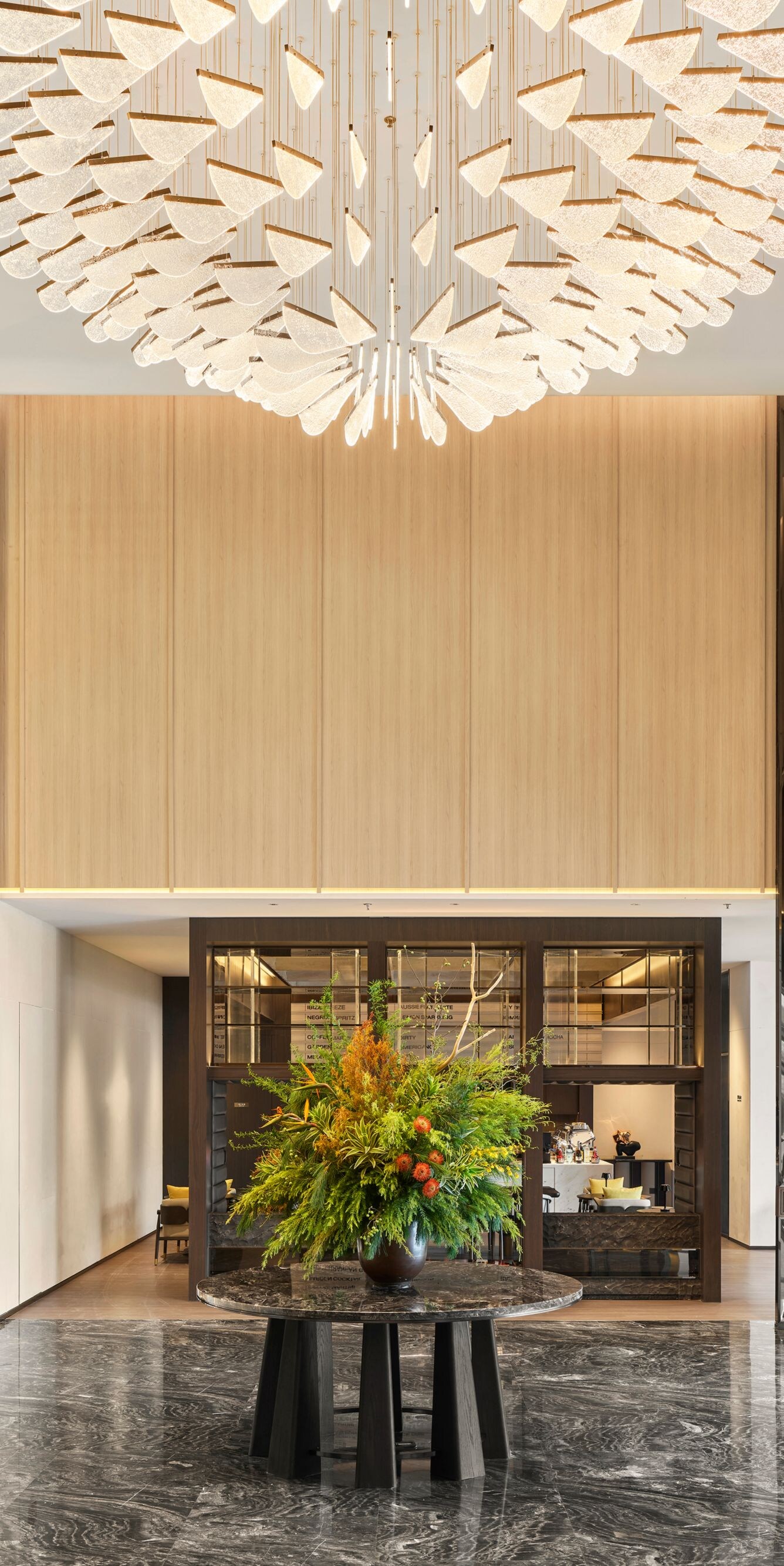 Hotel lobby with chandelier and floral centerpiece
