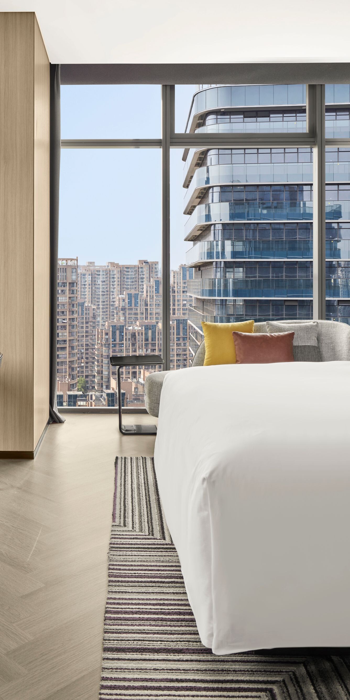 Modern guest room with city view and king bed