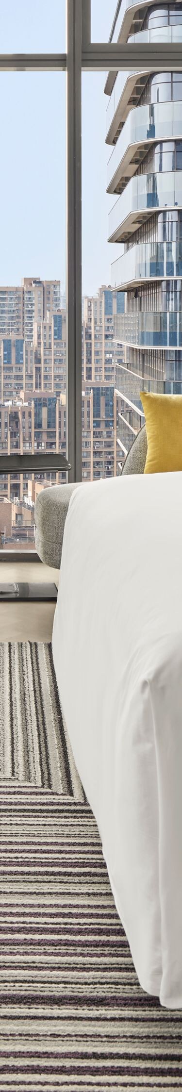 Modern guest room with city view and king bed