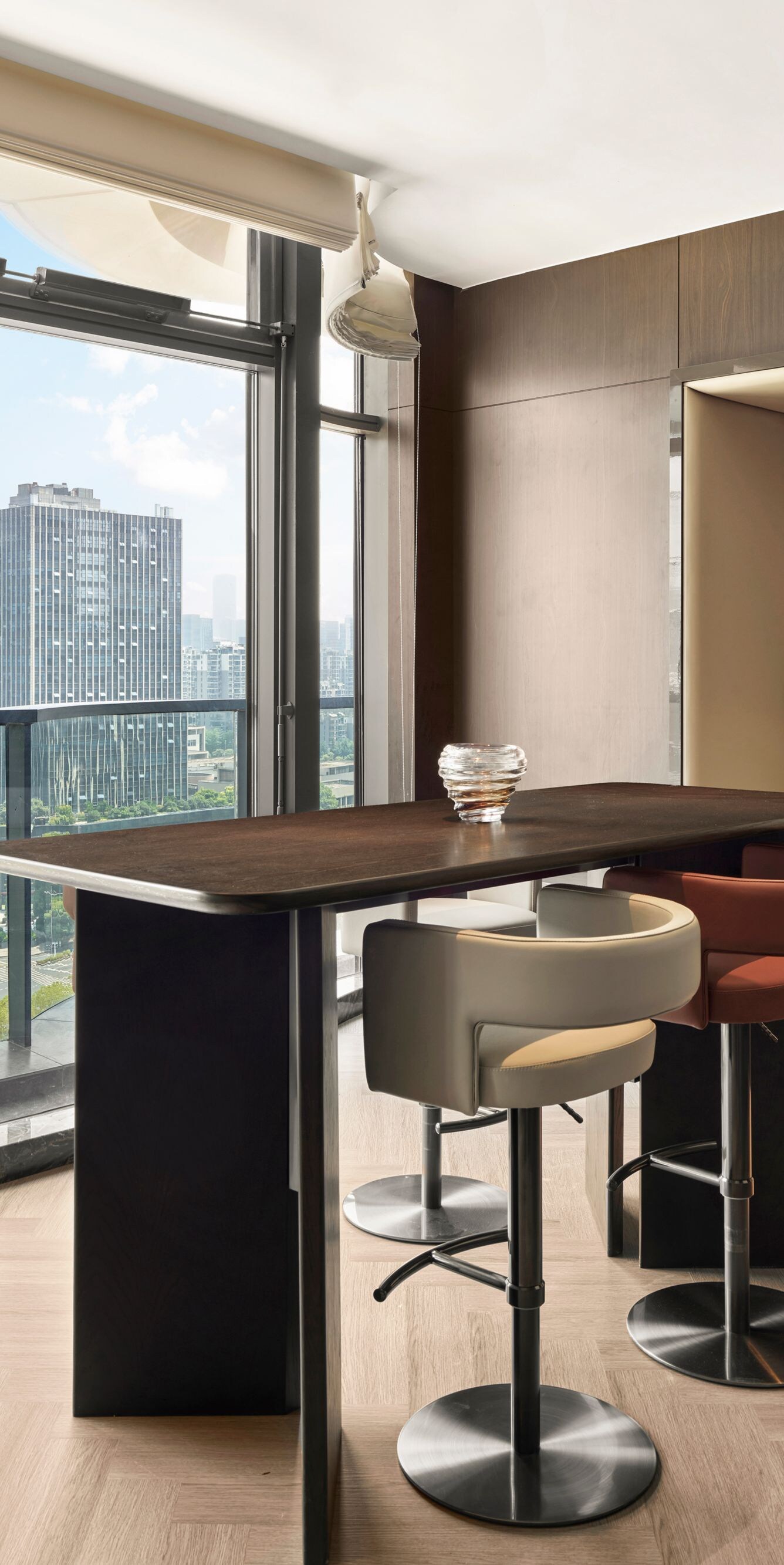 Window-side seating area with table and city view