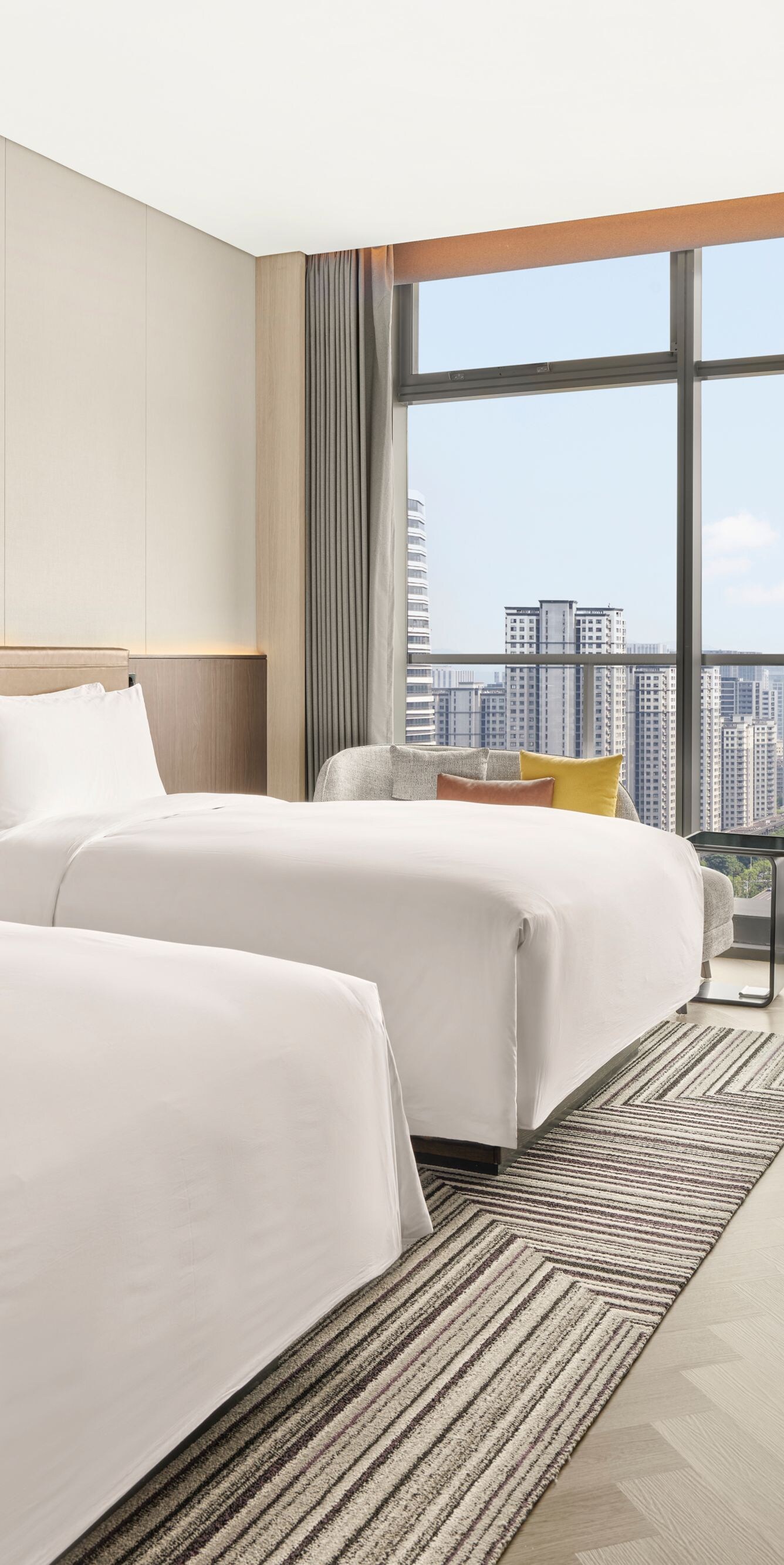 Two beds with city view and work desk