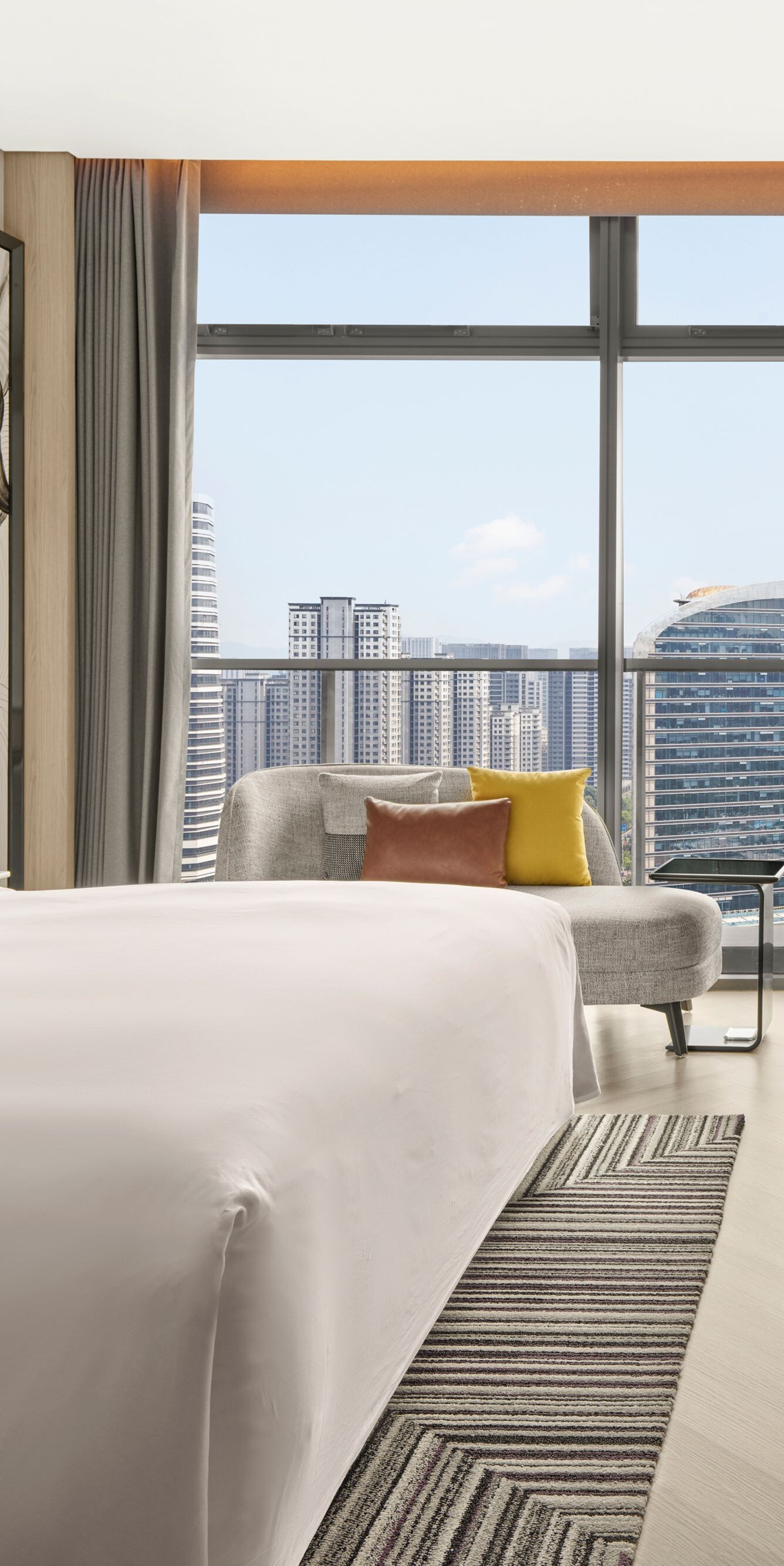 Modern hotel room with city view and king bed