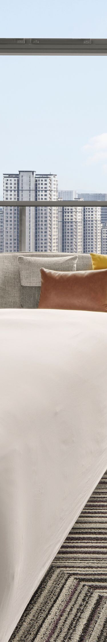 Modern hotel room with city view and king bed