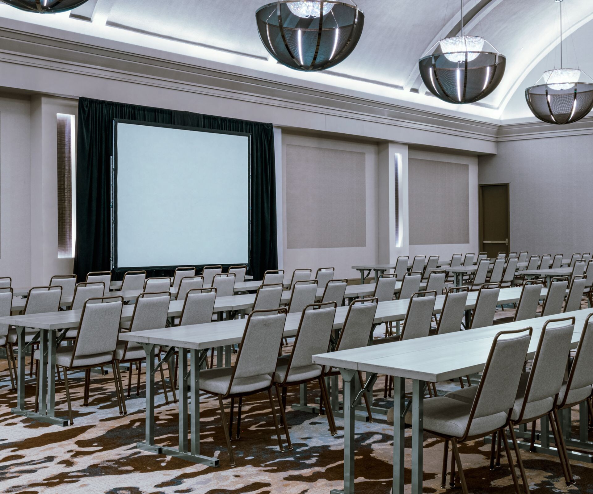 Ballroom with classroom seating & projector screen