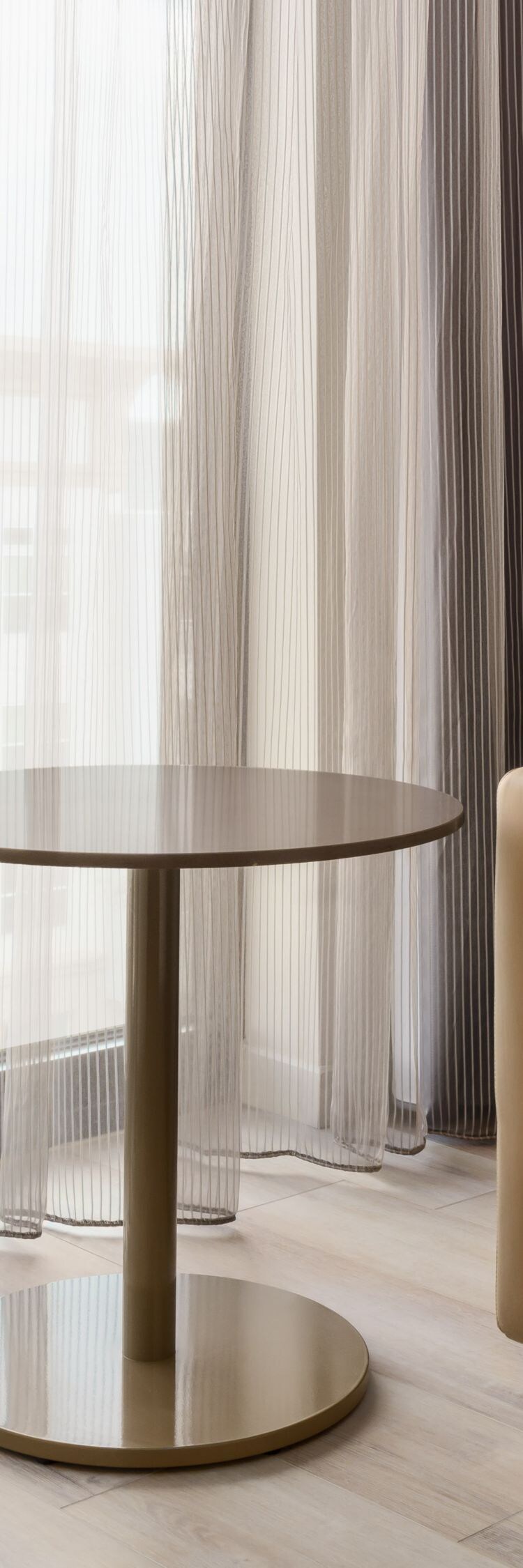 Leather chair with a small table, lamp, and window