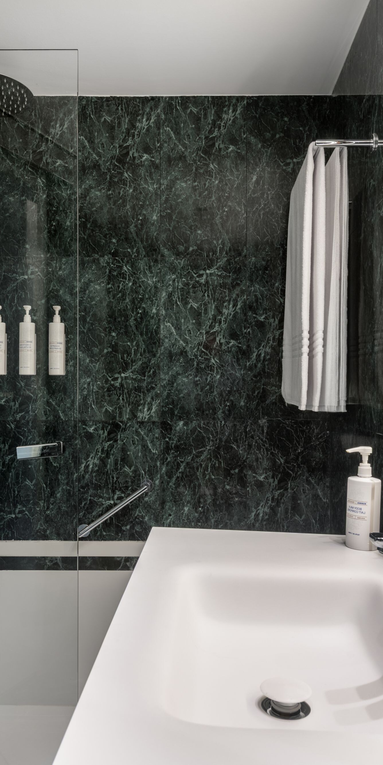 Bathroom with marble walls and rain shower