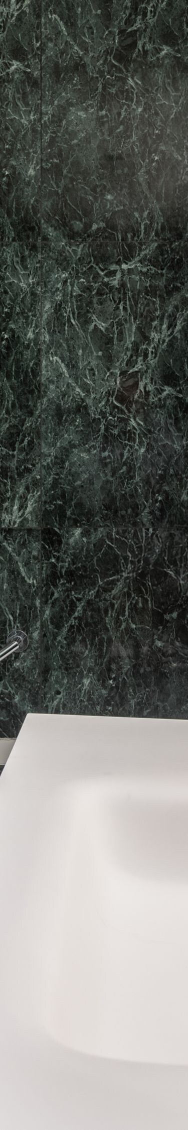 Bathroom with marble walls and rain shower