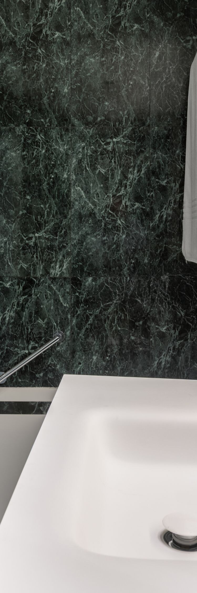Bathroom with marble walls and rain shower