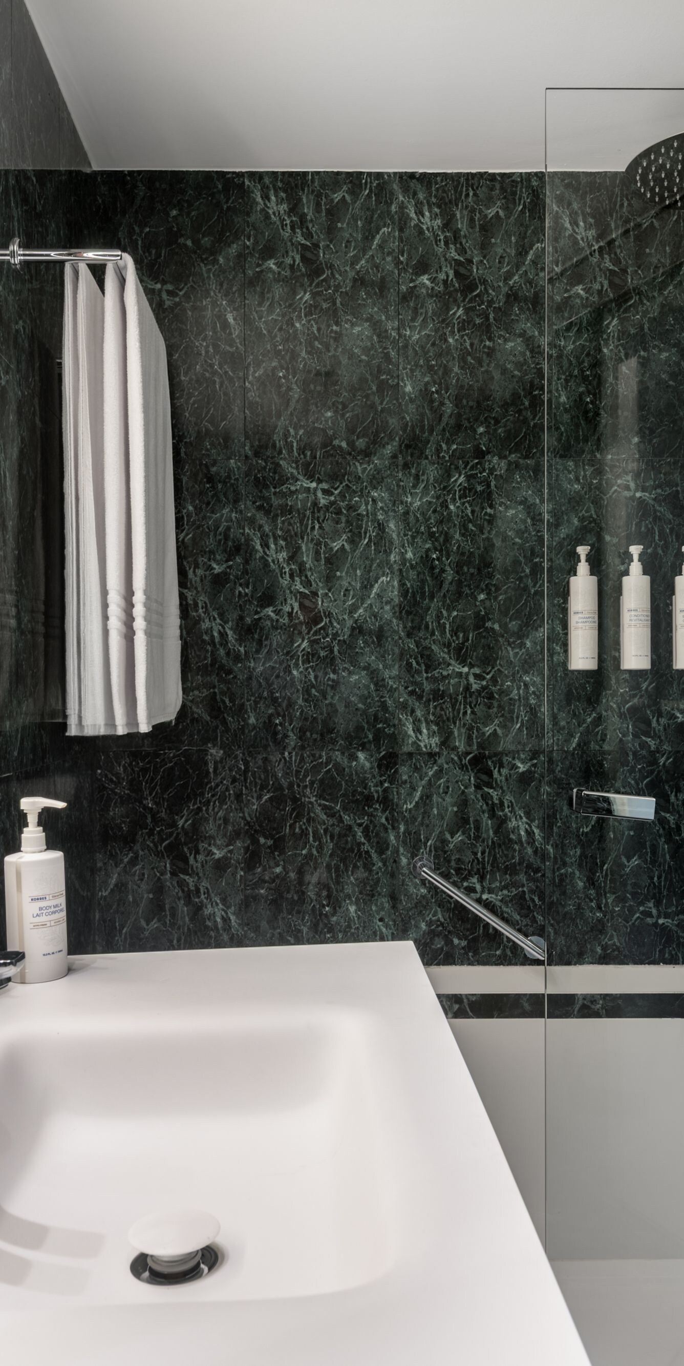 Bathroom with marble walls and rain shower