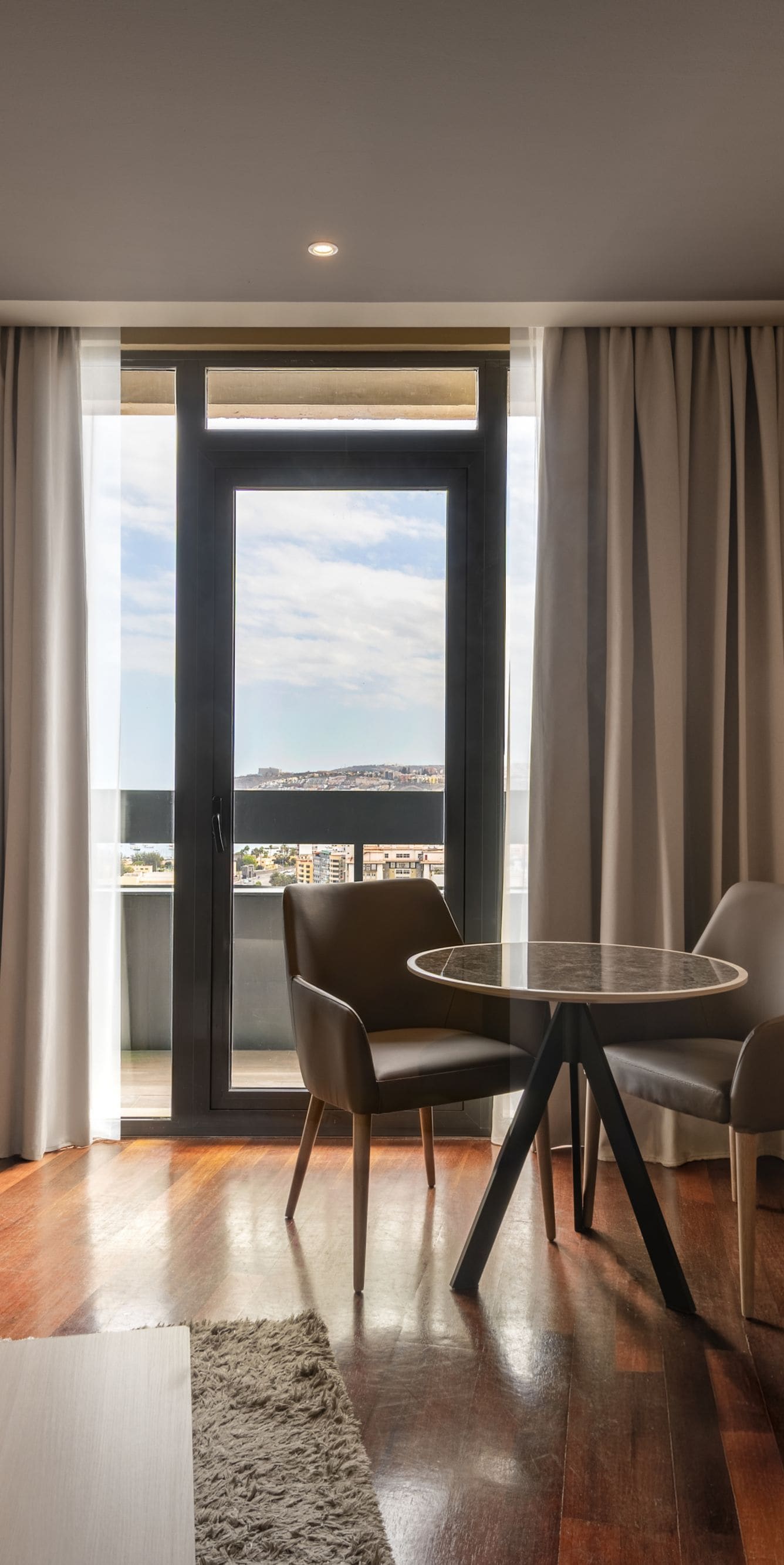 Suite living area with balcony and city view