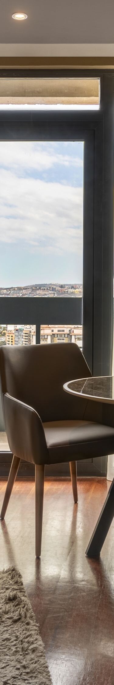 Suite living area with balcony and city view