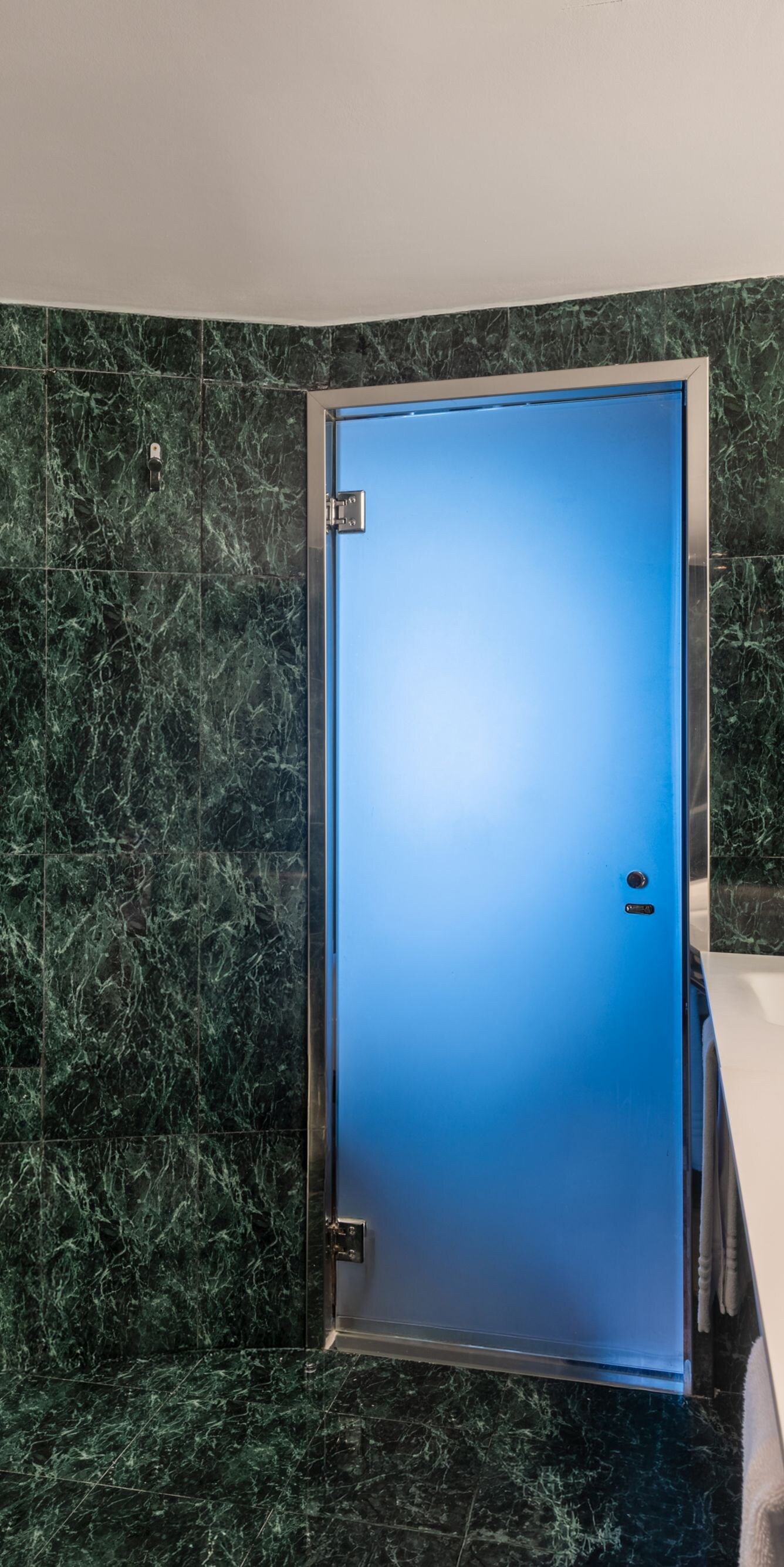Bathroom with green marble and dual vanity