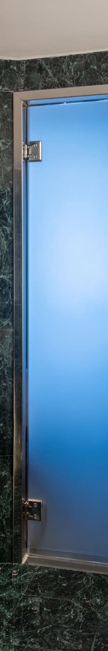 Bathroom with green marble and dual vanity