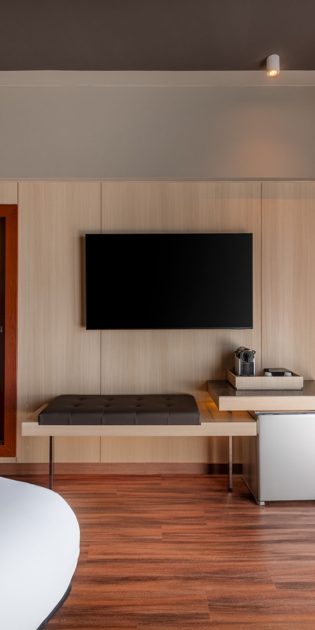 Guest room with TV and wood paneling