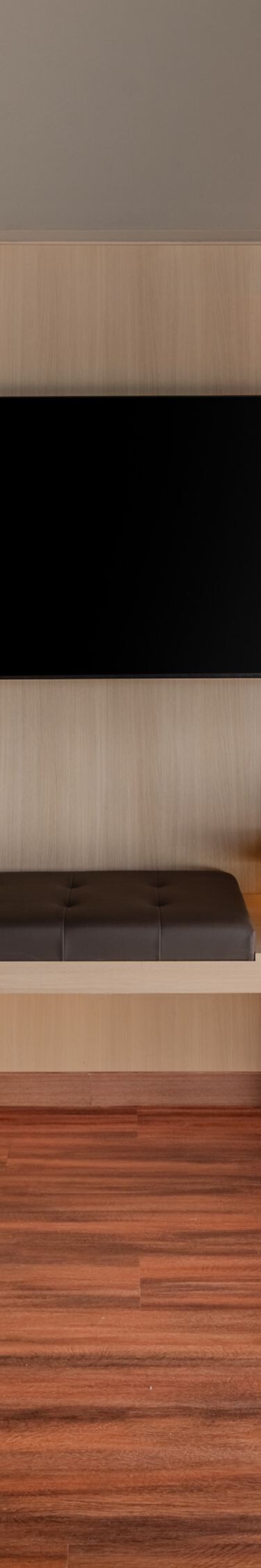 Guest room with TV and wood paneling