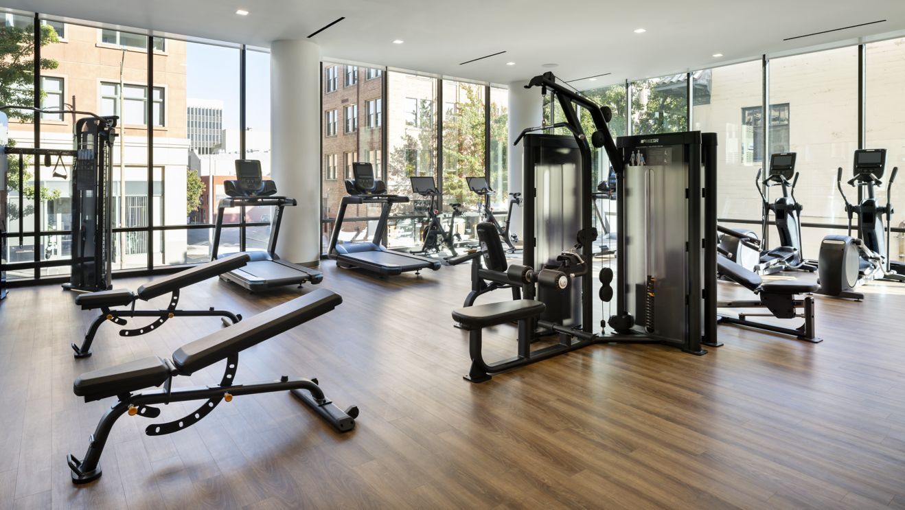 Fitness Center with wood floor, large windows.