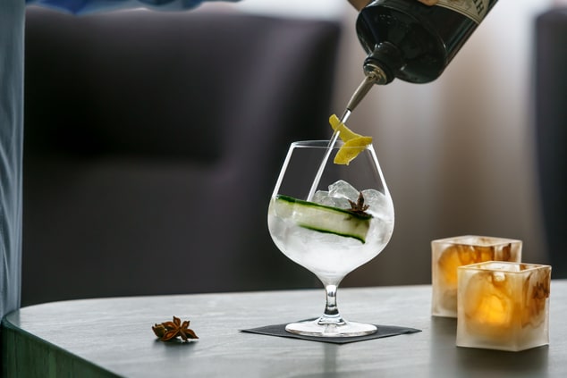 cocktail being poured into glass