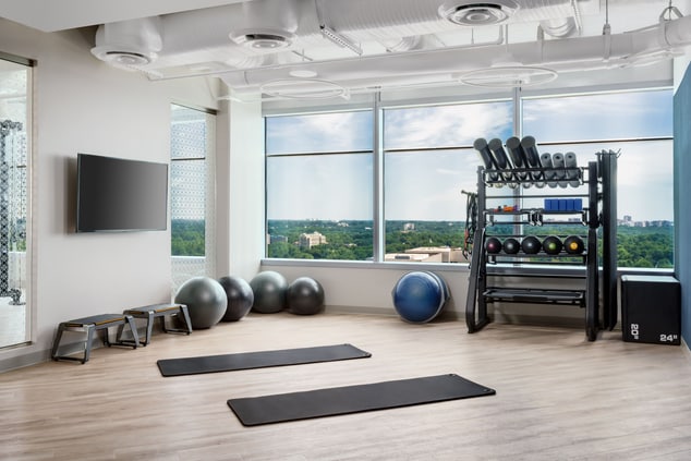 Workout room with yoga mats and weights