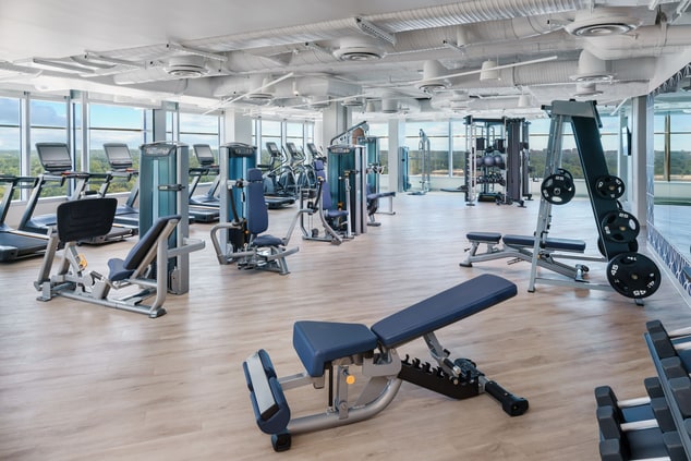 Workout area with equipment and window views 