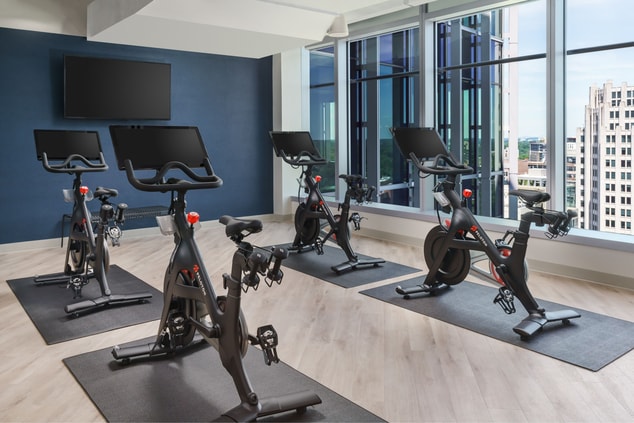 Peloton workout bikes in room with windows