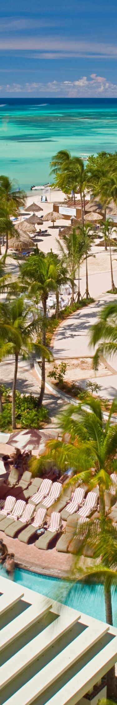 Aerial resort view with pool and beach.
