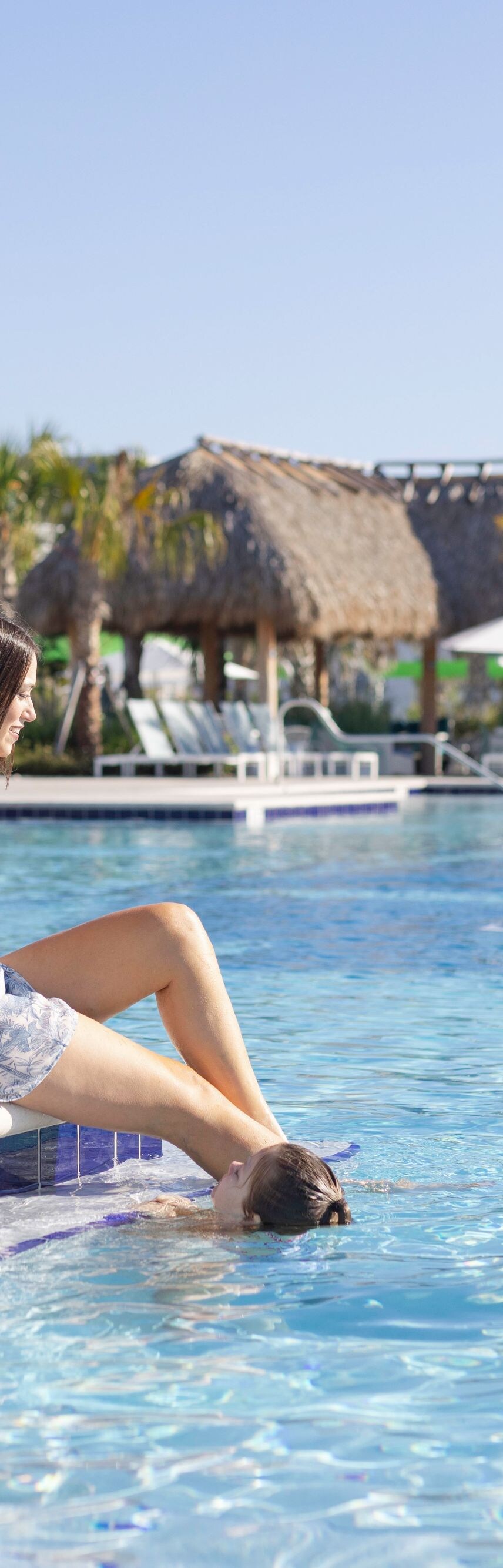 Guests standing in outdoor pool