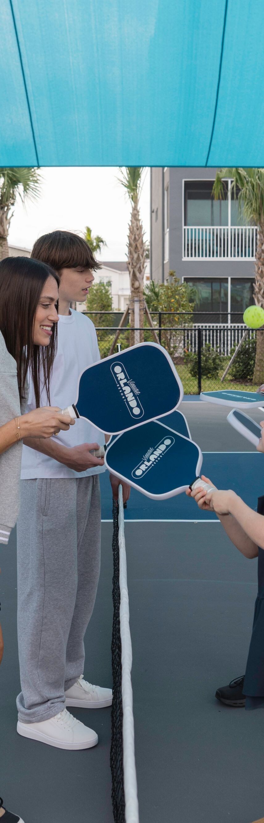 Group playing pickleball outdoors