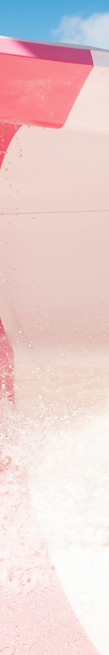 Person sliding down pink waterslide