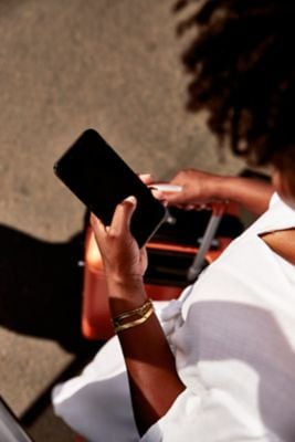 Woman in hotel lobby looking at smart phone