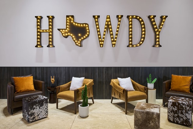 Hotel lobby with wall mural reading "Howdy" 