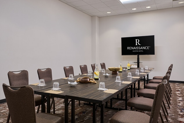 Image of a meeting room with table settings