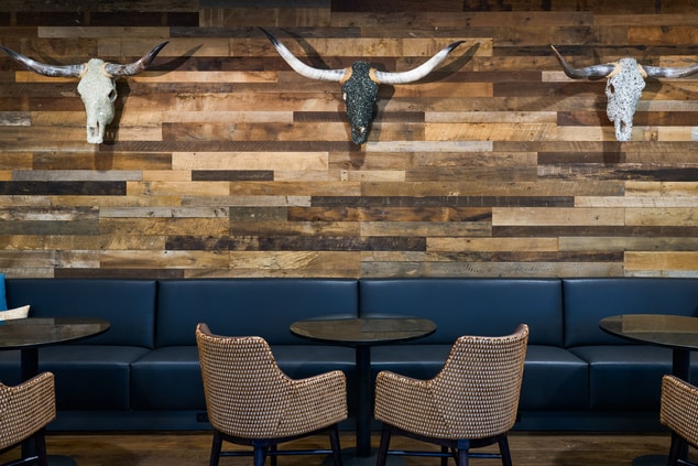 Concierge lounge seating area with longhorn wall.