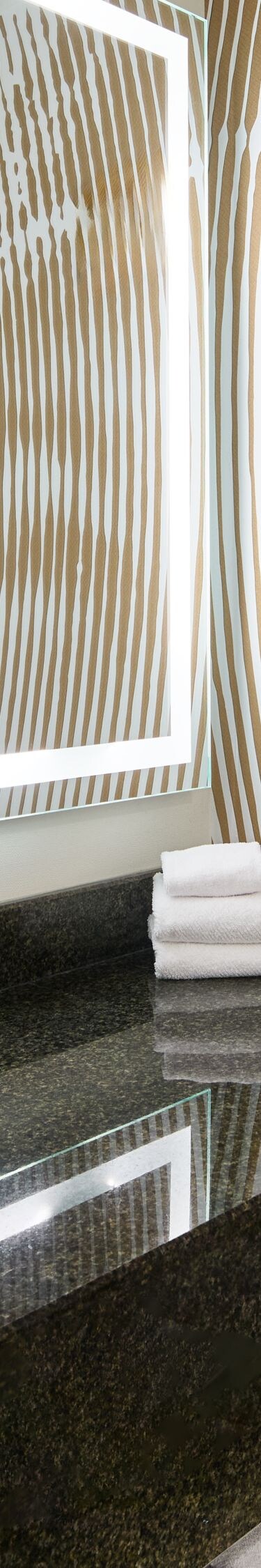 Hotel bathroom with large mirror, sink vanity