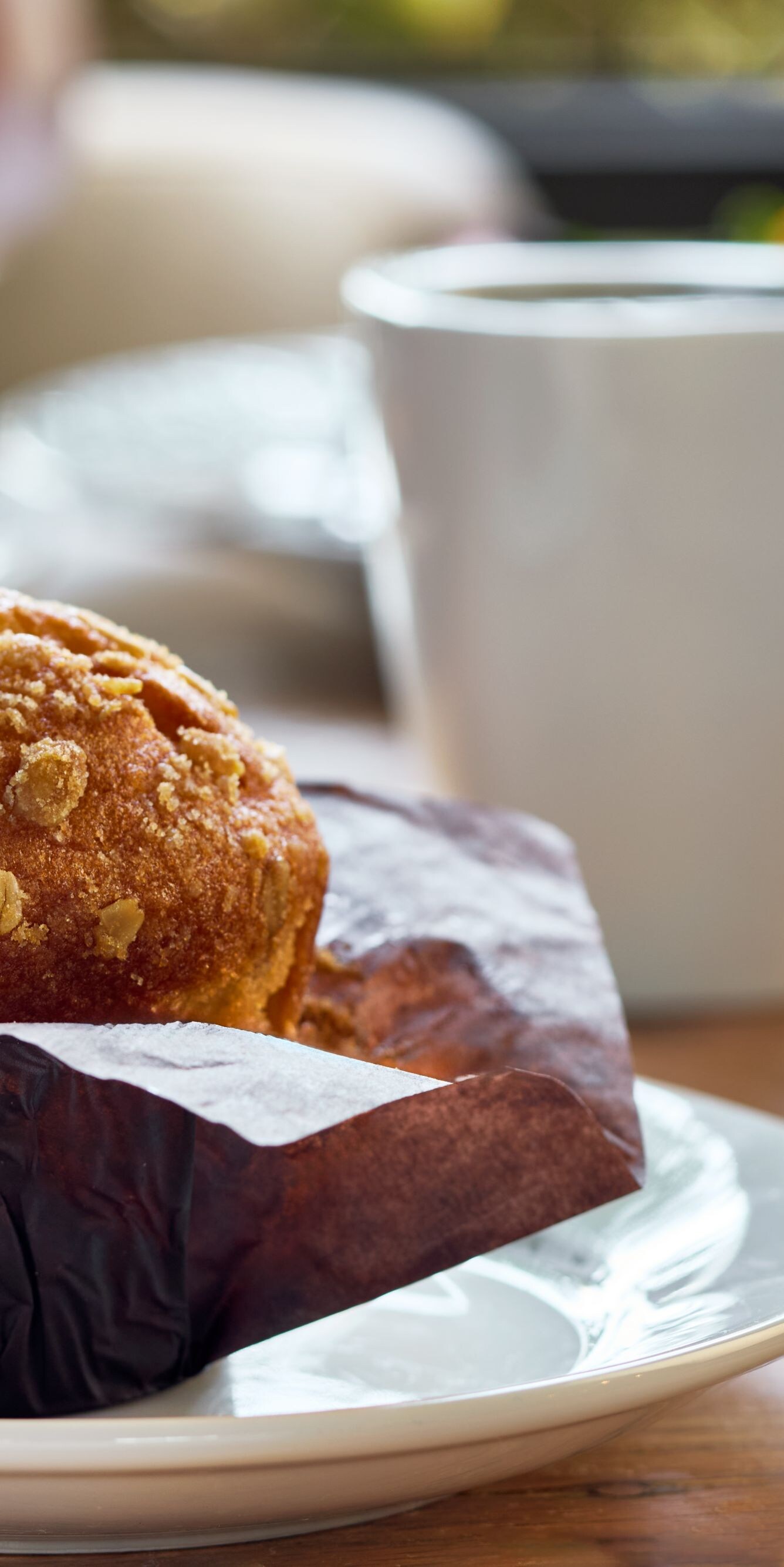 Breakfast muffin on a plate with a cup of coffee