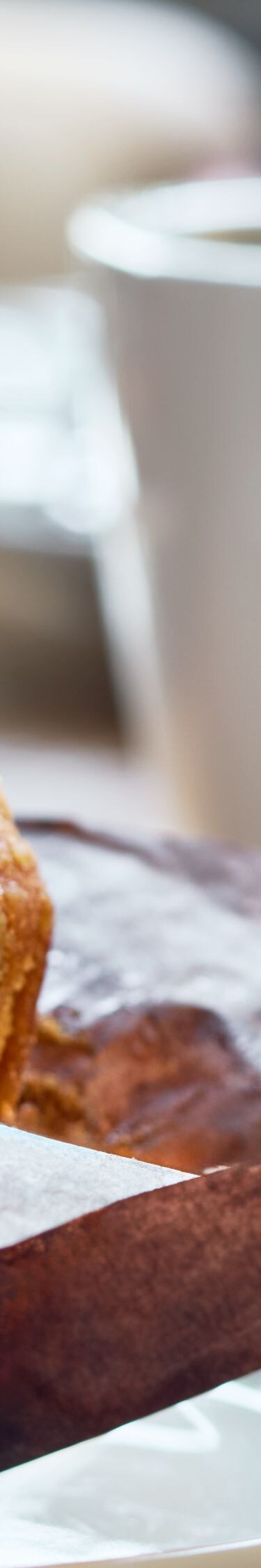 Breakfast muffin on a plate with a cup of coffee