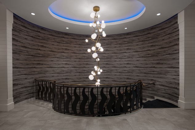 Grand staircase with dangling light fixture