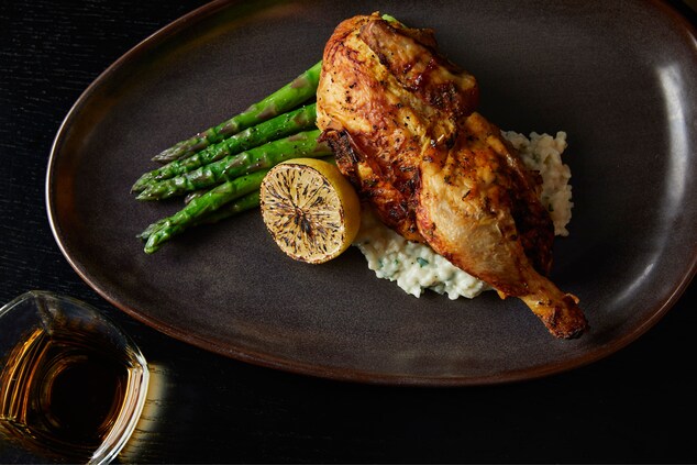 Chicken over mashed potatoes with asparagus.