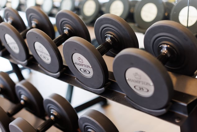 Free weights sitting on a rack in a gym