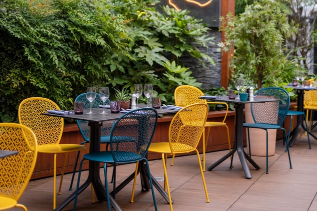 Outdoor restaurant, green walls and artwork 