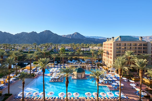 Aerial view of resort with pool and mountains
