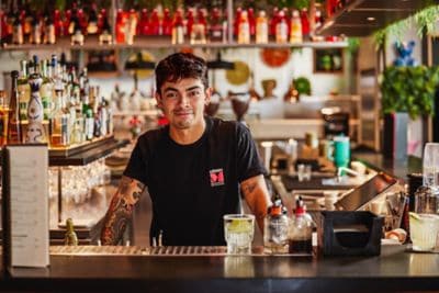 A bartender looking at the camera