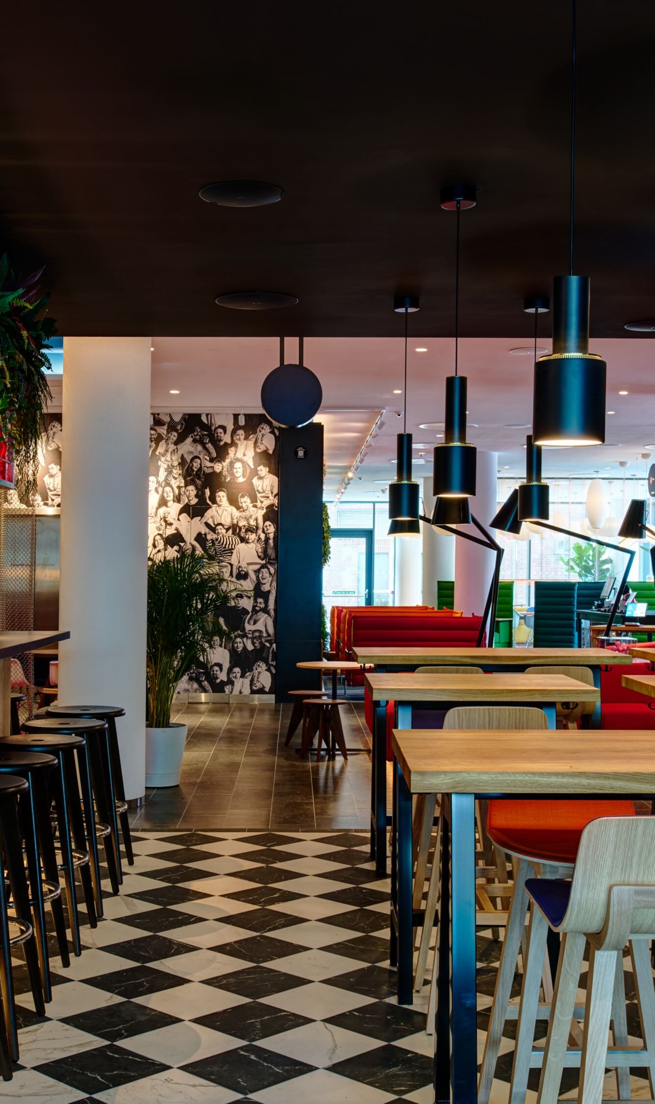 Modern bar with checkered floor and barstools.