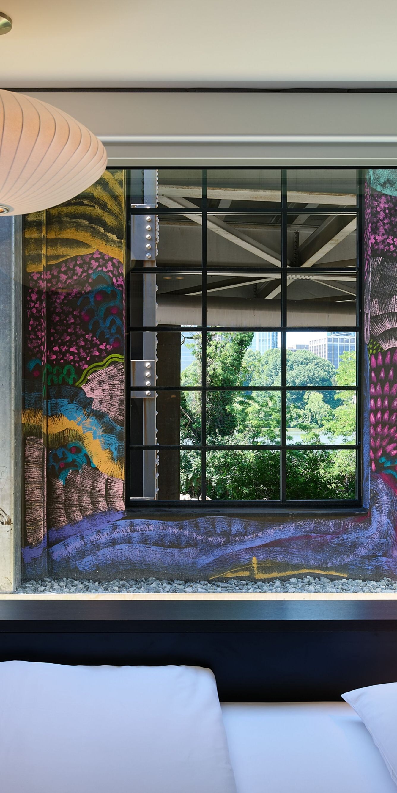 Guest room with a king-sized bed and mural view