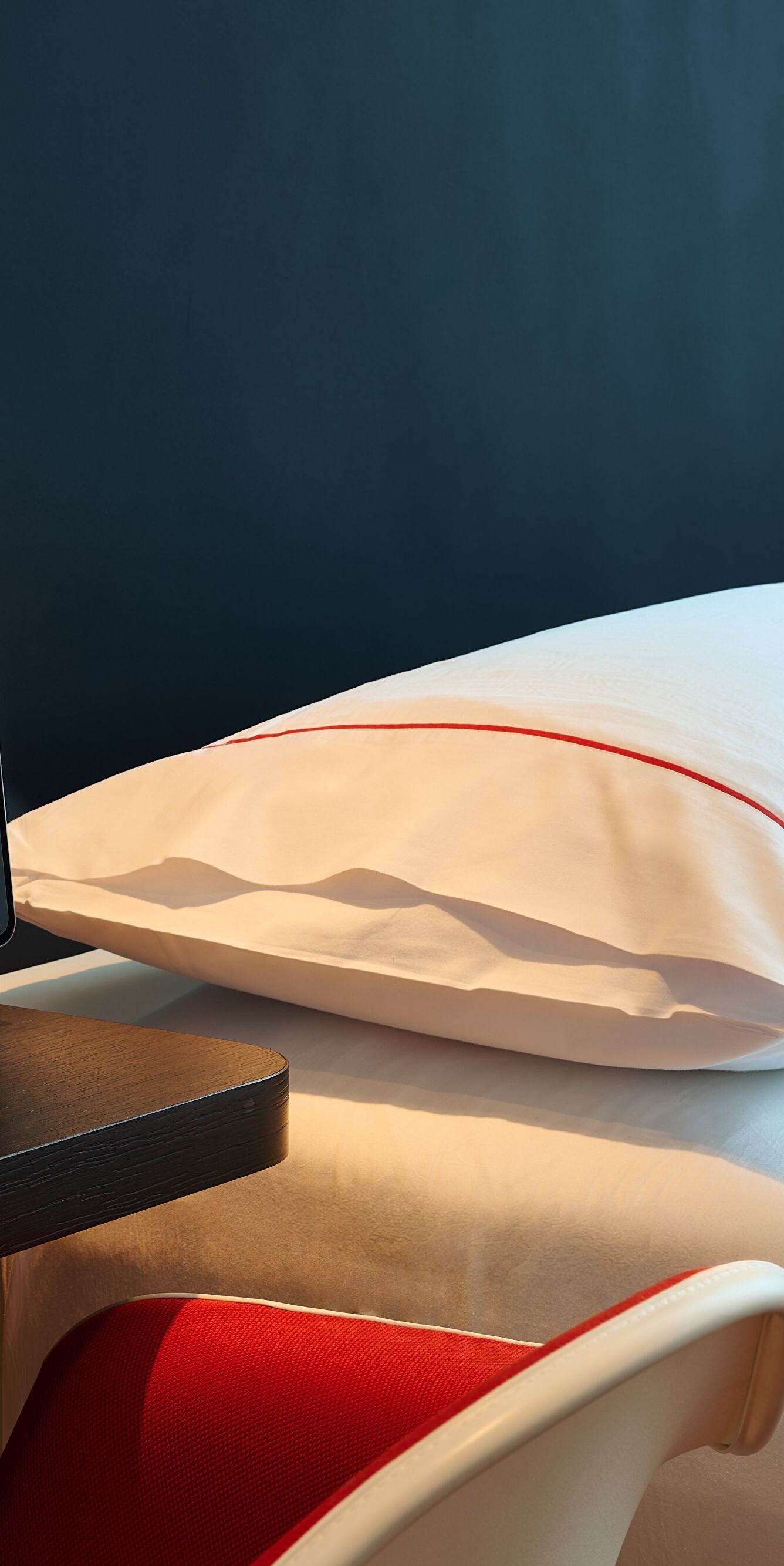 Guest room with a bedside table and tablet 