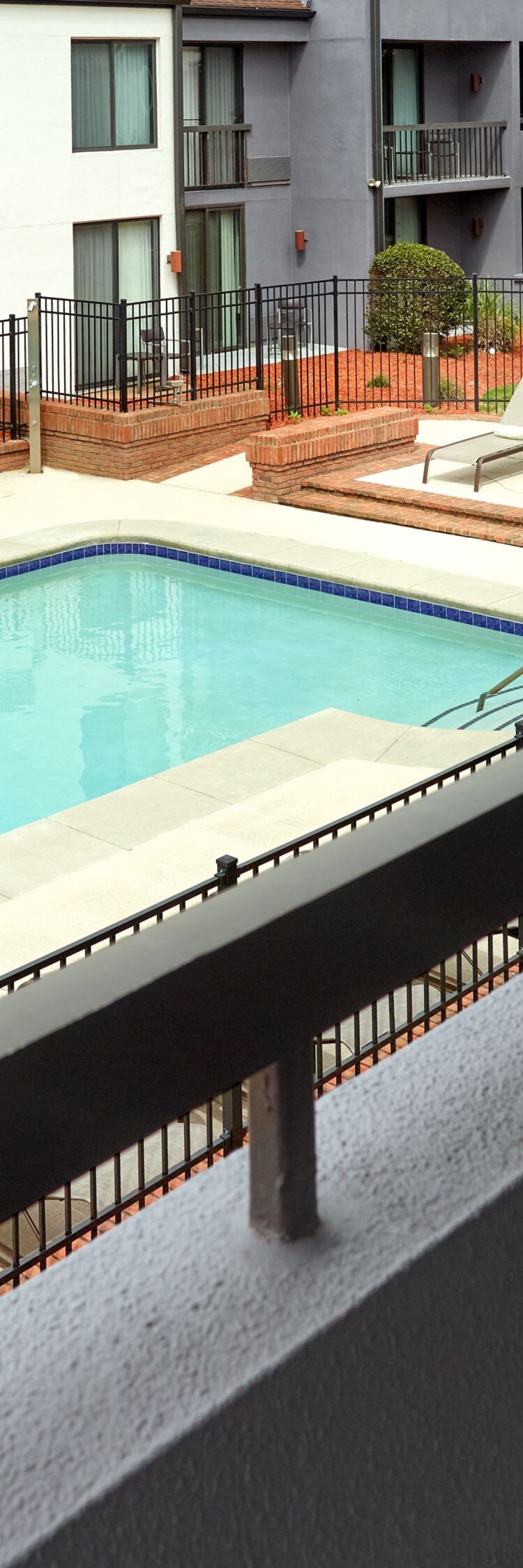 Two chairs on balcony overlooking the pool